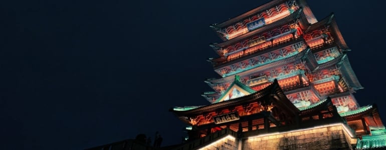 A traditional Chinese house lightened under the dark night sky.