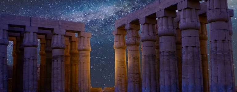 Columns of Acropolis of Athens in Greece under the starry night sky.