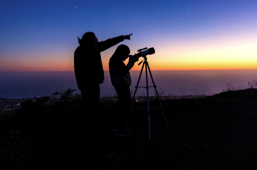 A family looking at stars with a telescope