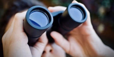 A person looking through binoculars