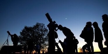 People watching stars with telescopes