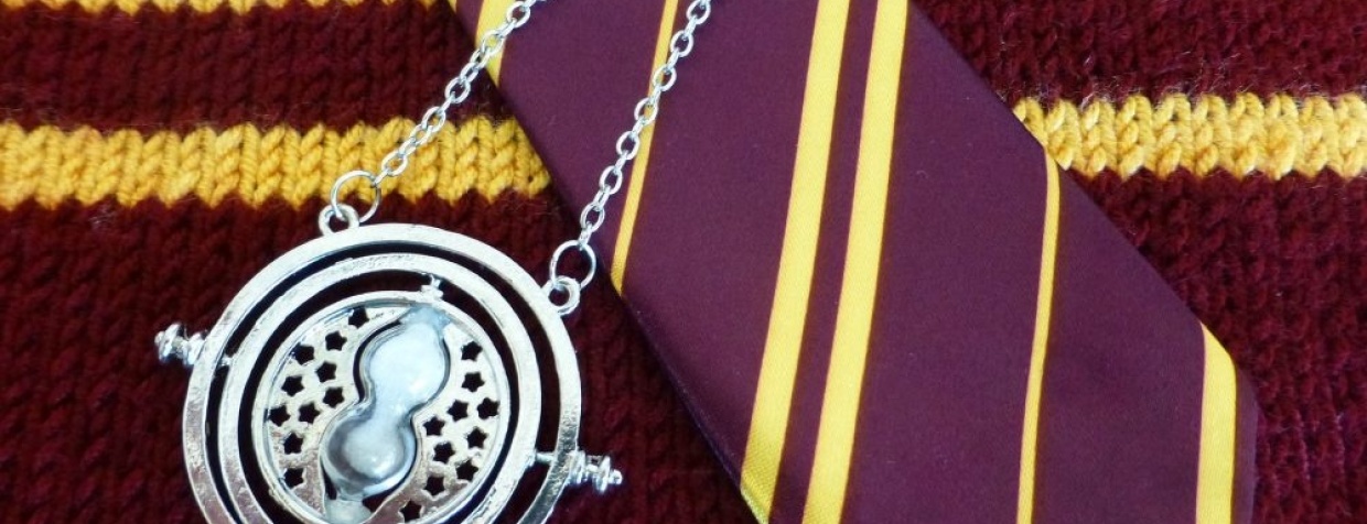 Medallion on top of red and yellow tie and a sweater