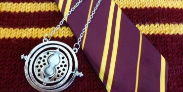 Medallion on top of red and yellow tie and a sweater
