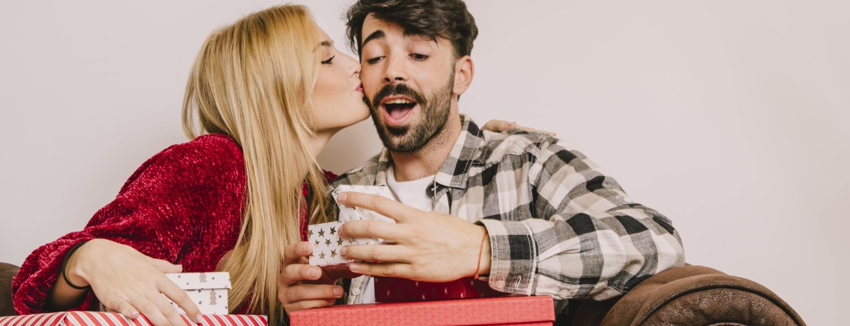 A happy couple exchanging gifts.