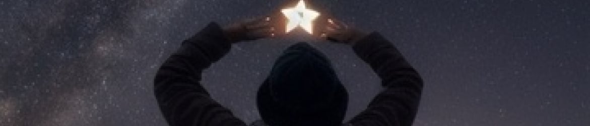 person reaching for a star