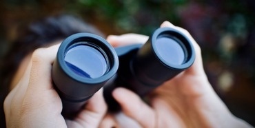 A person looking through binoculars