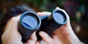 A person looking through binoculars