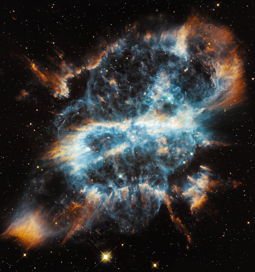 A star exploding and throwing brown and blue dust around it in a shape of an "s"