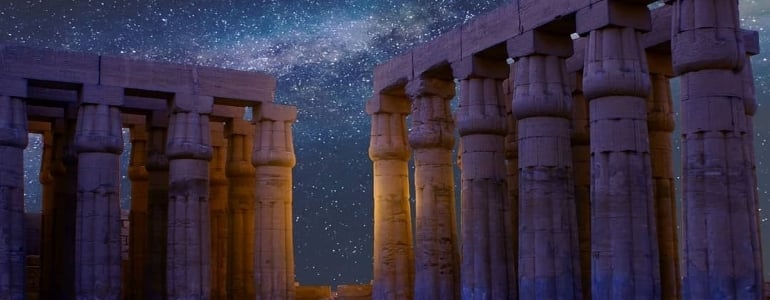 Columns of Acropolis of Athens in Greece under the starry night sky.