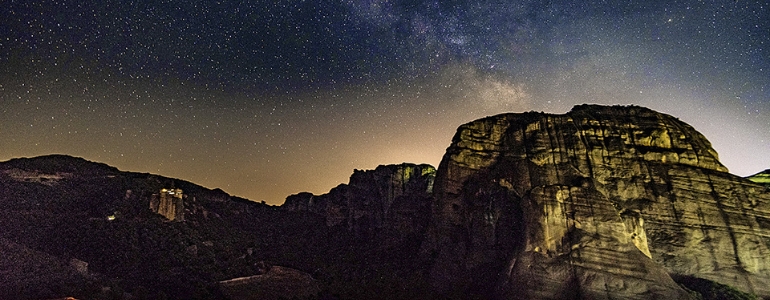 Starry night sky and over the mountainous region.