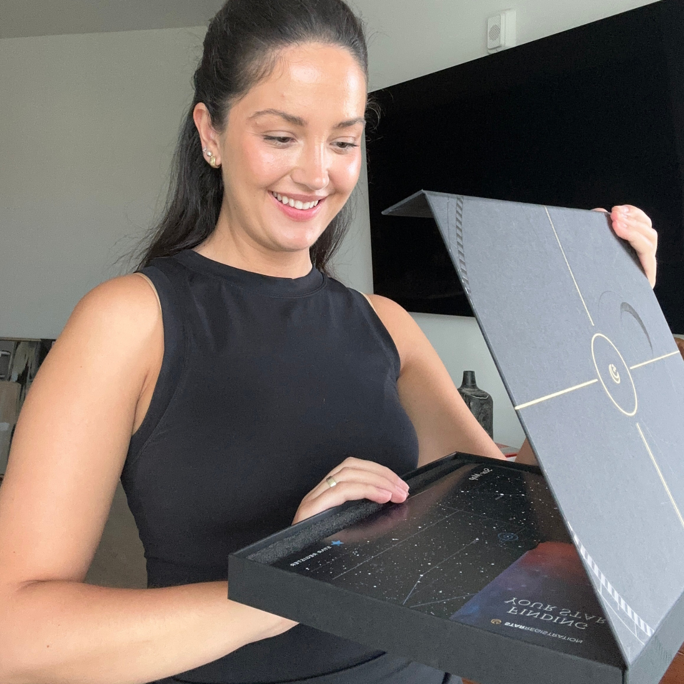 A happy customer opening her star registration certificate.