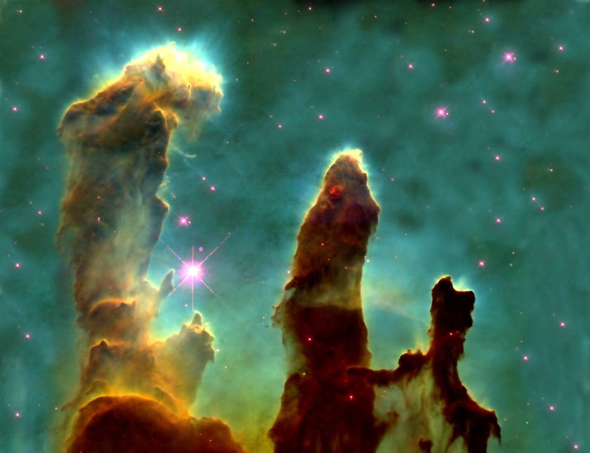 Brown cosmic dust creating large pillars in a green universe with glowing stars around them