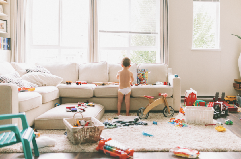 A child standing in a messy room