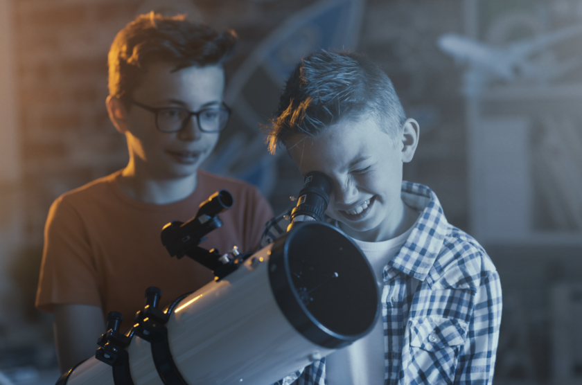 boys looking through a telescope