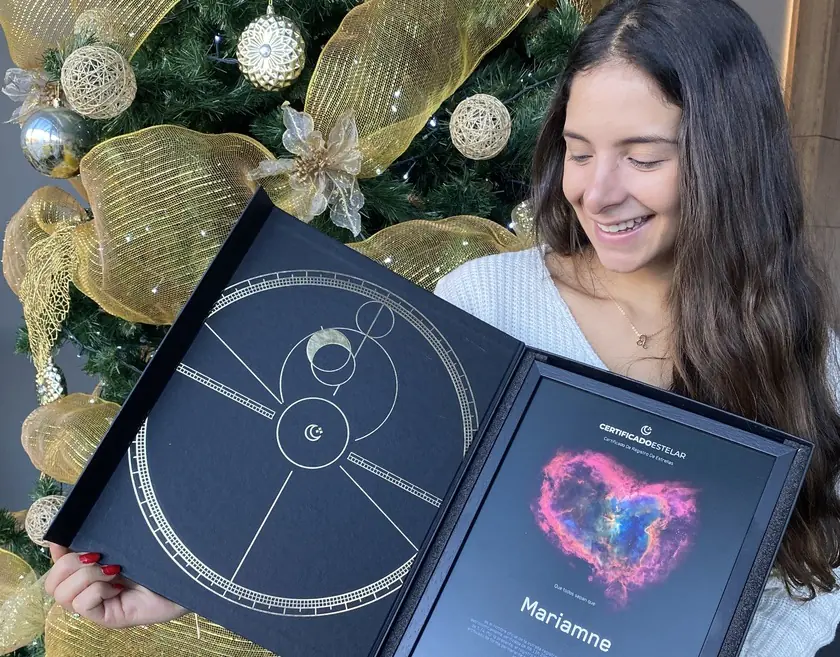 A happy woman holding a star certificate.