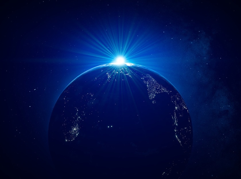 The Earths' globe as seen from space with the Sun rising above its horizon