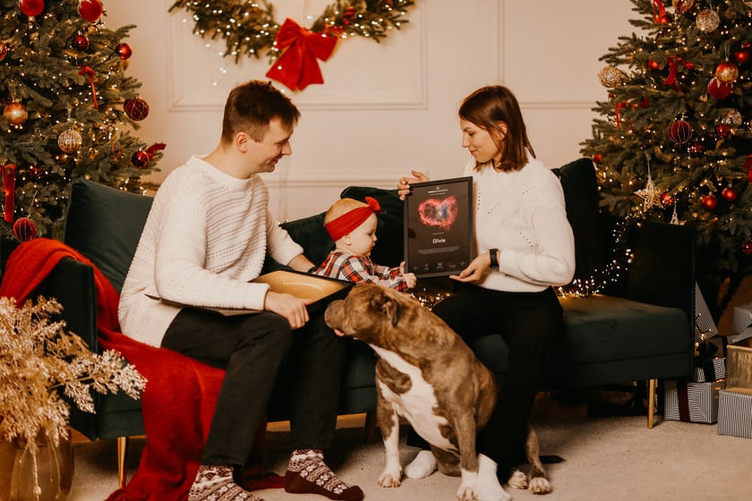 Family celebrating christmas and giving a star registartion certificte as a christmas gift 