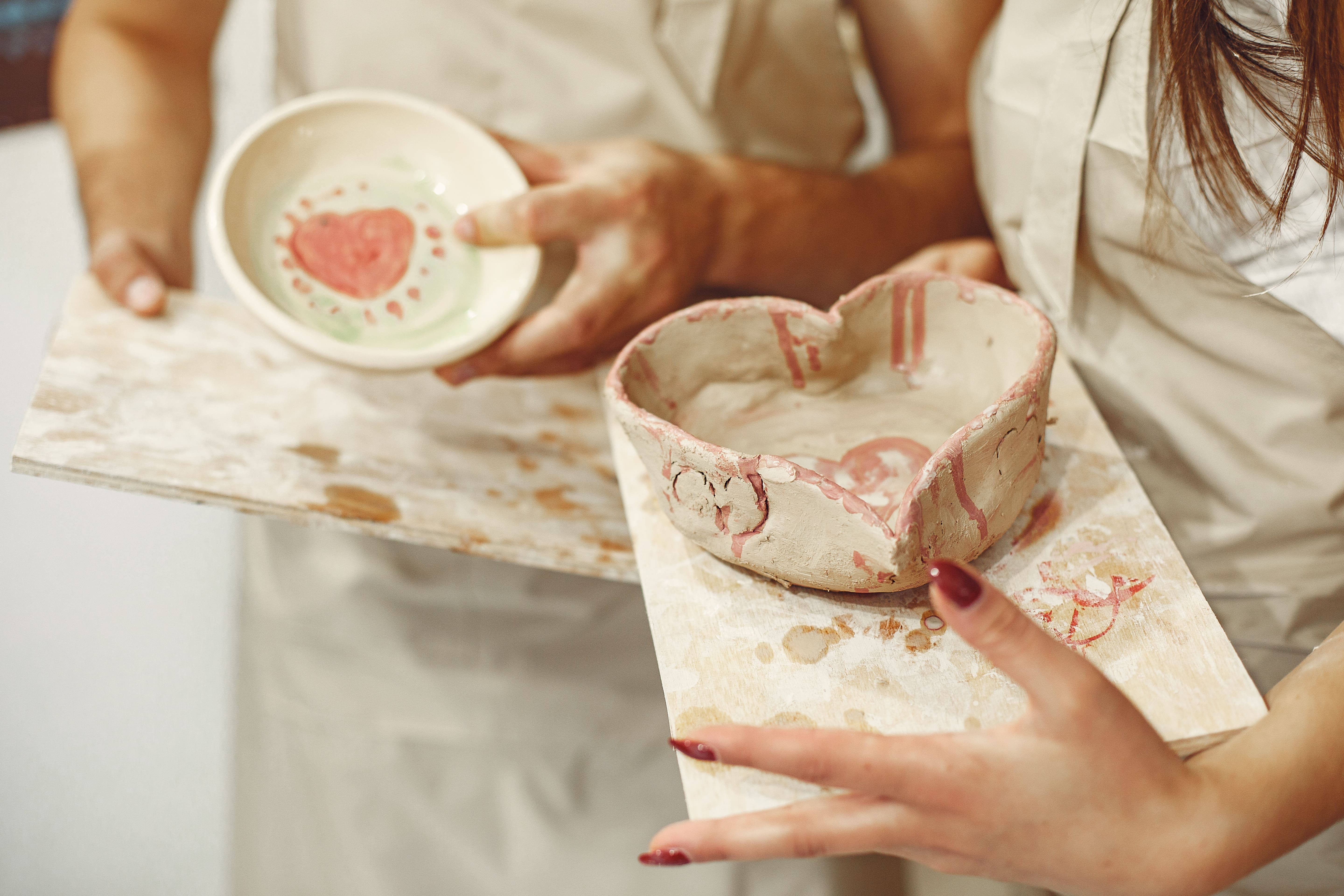 A couple holding self-made pottery.