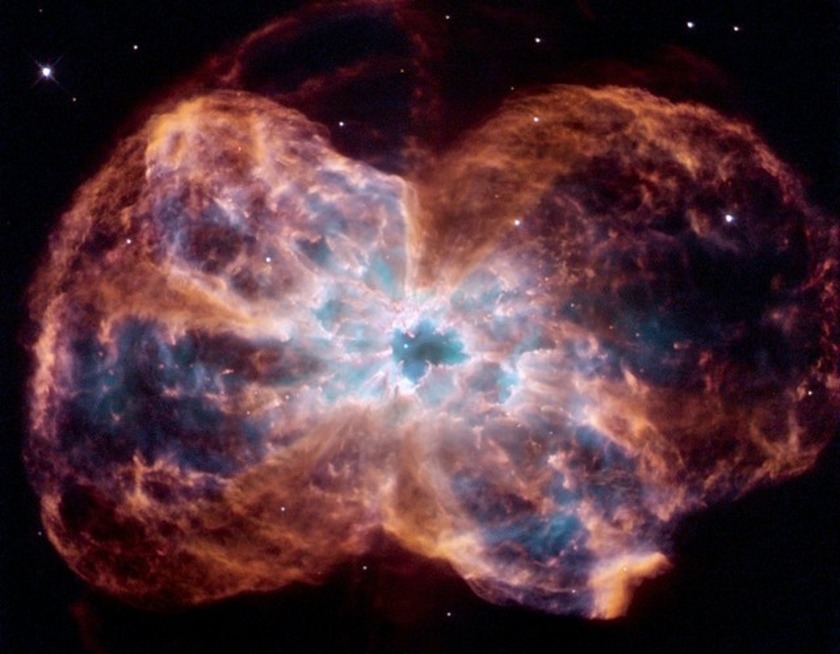 A star supernova explosion with brown, purple and blue dust being thrown out