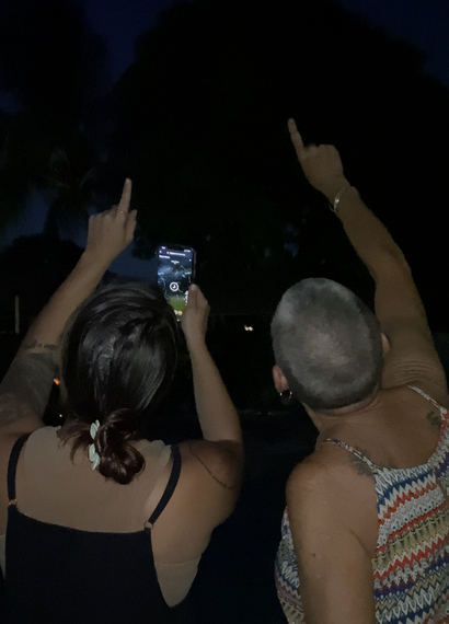 two people pointing at the stars using star finder app