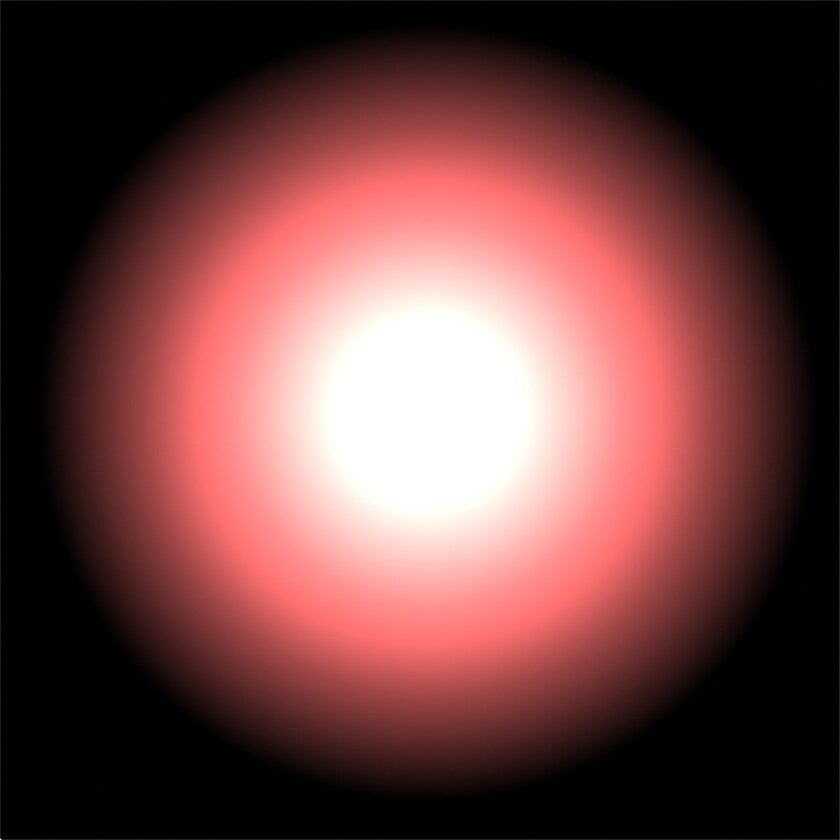 A young pinkish star that looks blurry because of dust around it