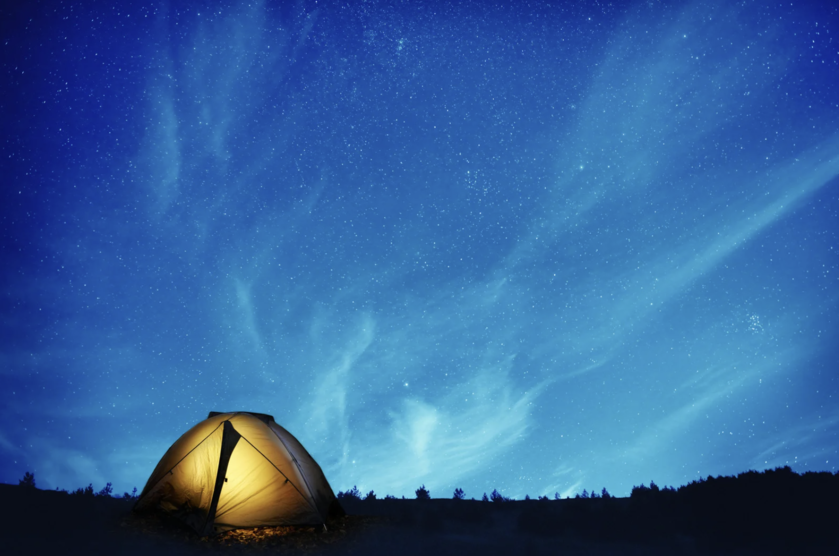 yellow tent under the starry night sky