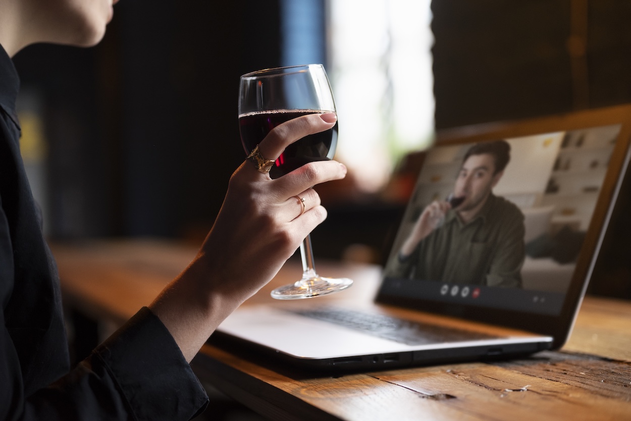 A couple on a virtual wine tasting date.